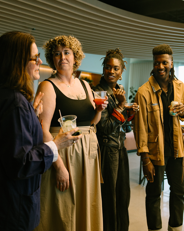 Team members speaking together at an office gathering