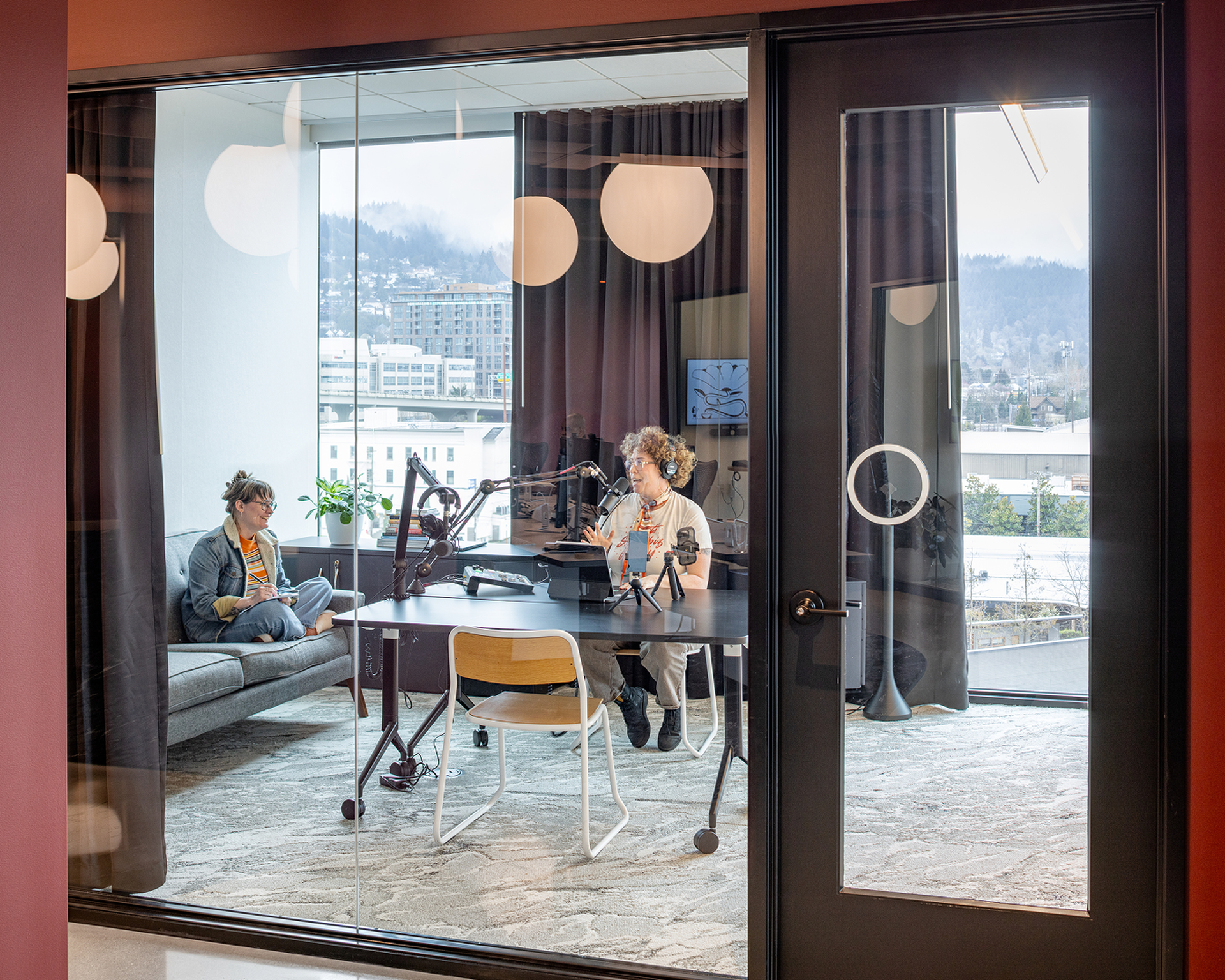 People recording a conversation in a bright creative studio
