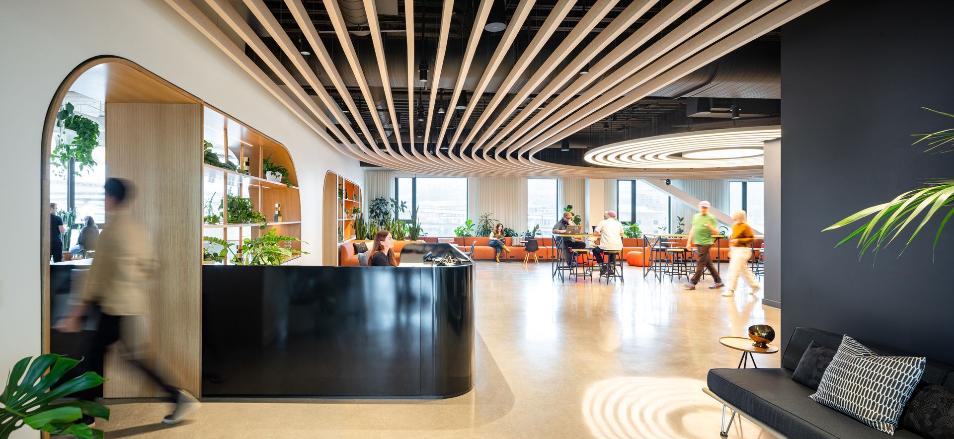 Open office lobby with people moving through a bright workspace