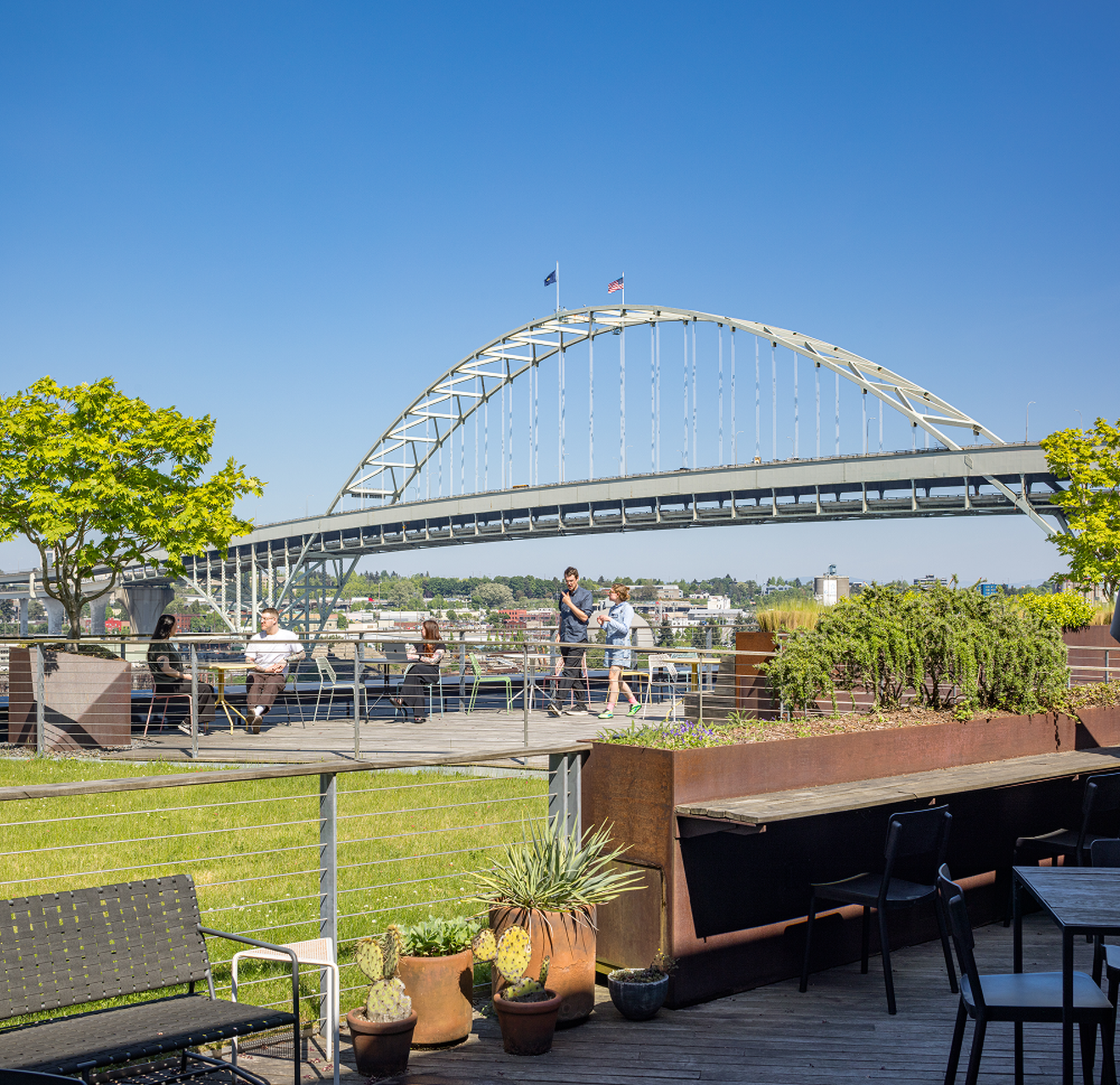 Outdoor terrace workspace with people and city view